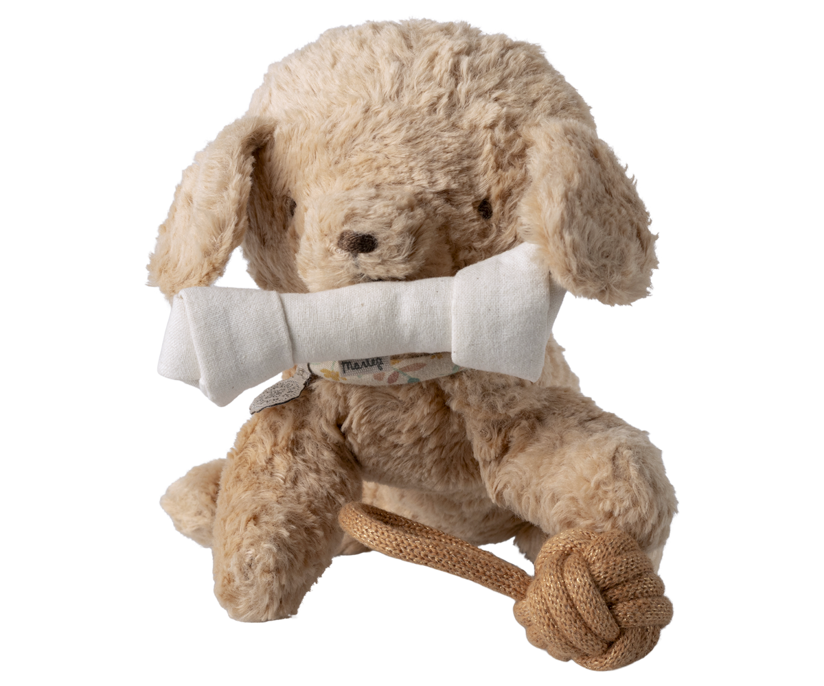 Beige plush dog toy with a white bone and brown rope on a white background