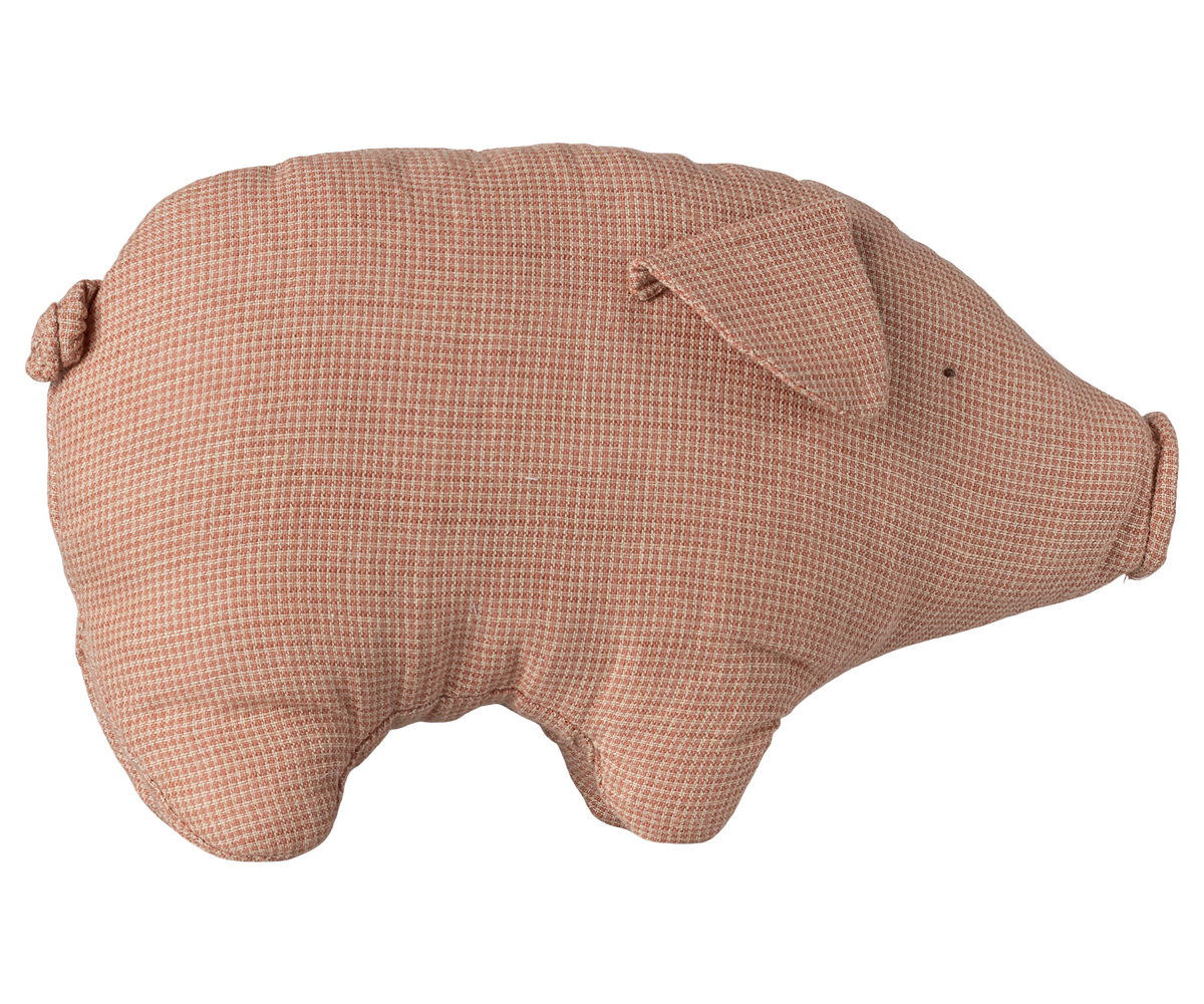 A soft, dusty pink linen stuffed pig toy with a simple stitched face and a small curled tail, viewed from the side against a transparent background.