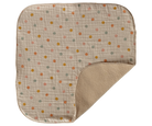 Baby blanket with polka dot pattern on beige background
