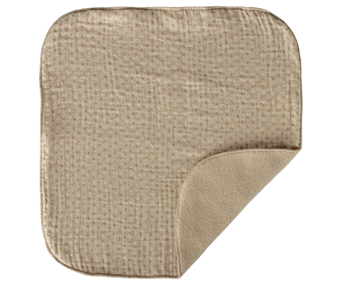 Textured beige mat on a white background