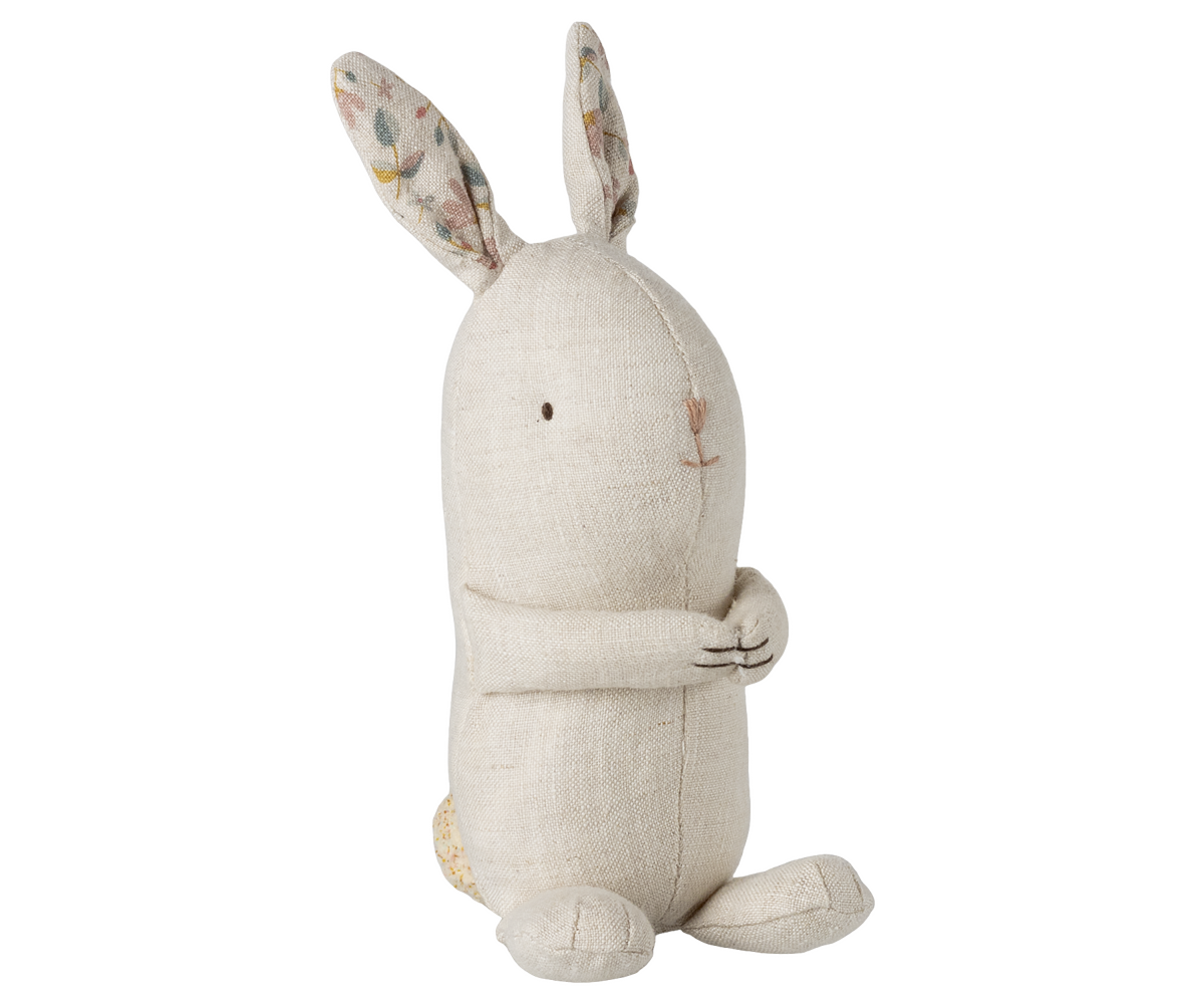 Stuffed rabbit toy with patterned ears on a white background