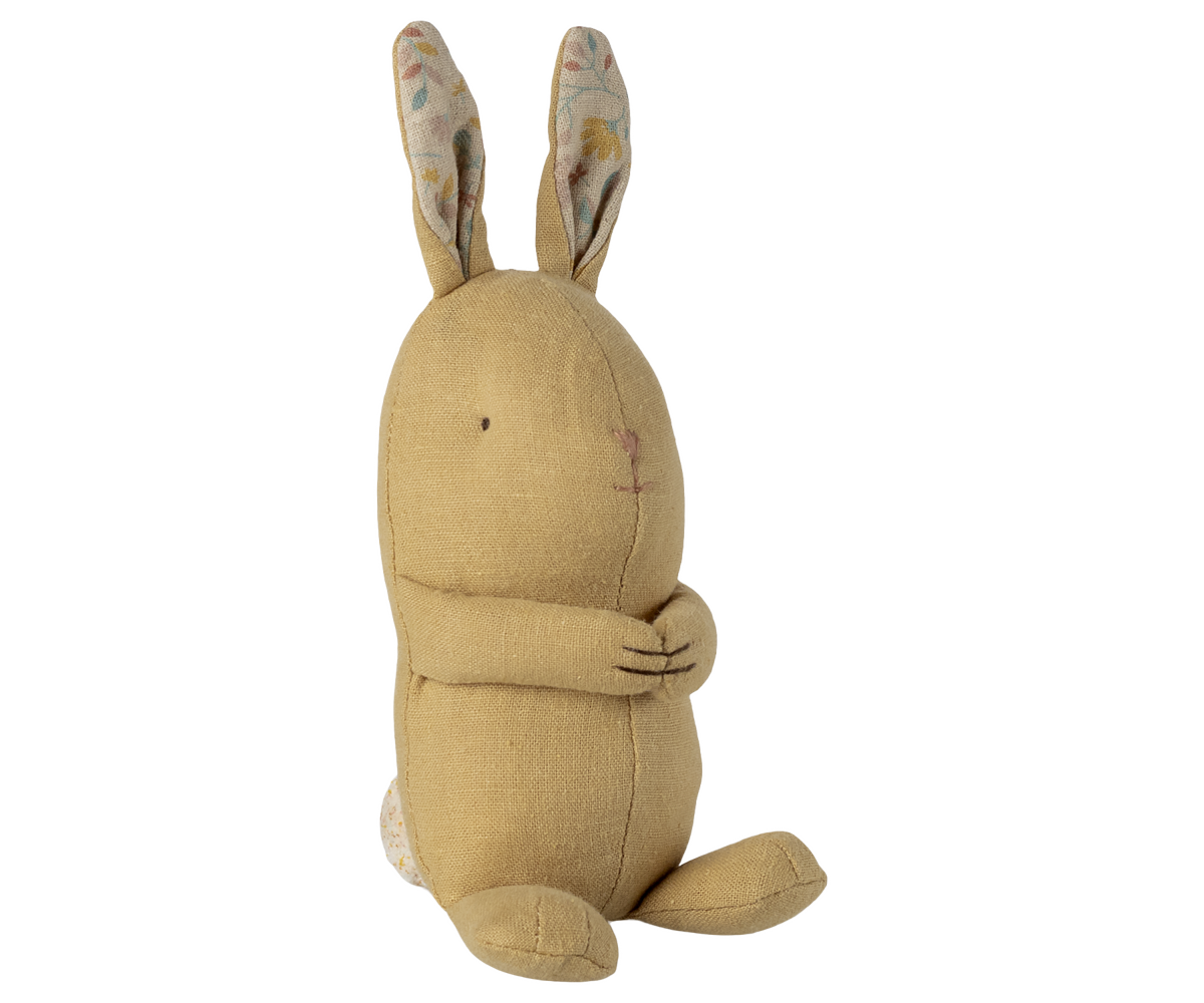 Beige plush bunny toy with patterned ears on a white background