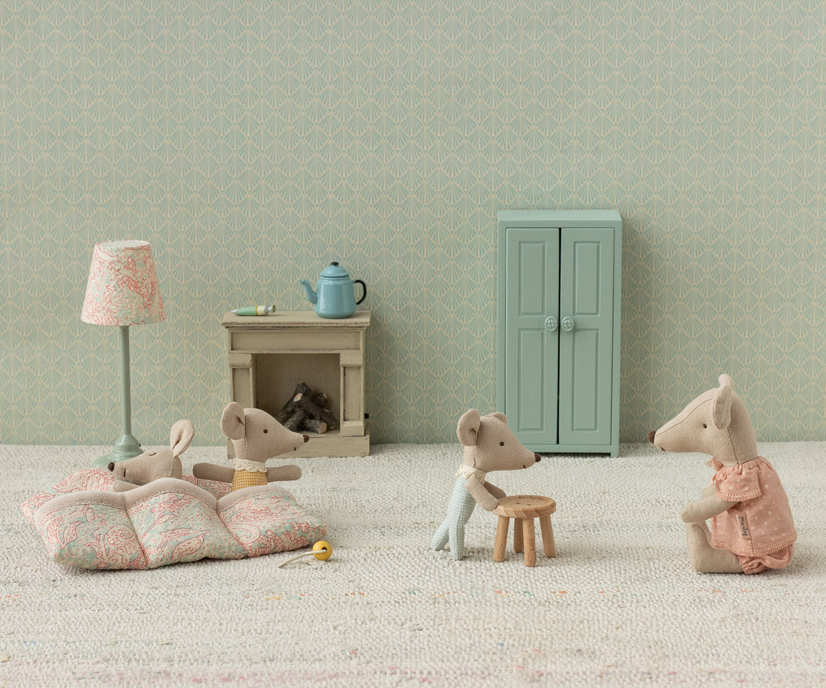 Miniature mouse figures in a room with furniture and decor.