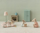Miniature mouse figures in a room with furniture and decor.