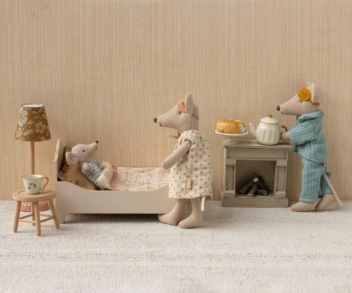 Maileg Mum mouse standing beside a miniature bathtub where Dad mouse sits inside, set in a dollhouse bathroom with a small toilet, sink, and tiled floor.