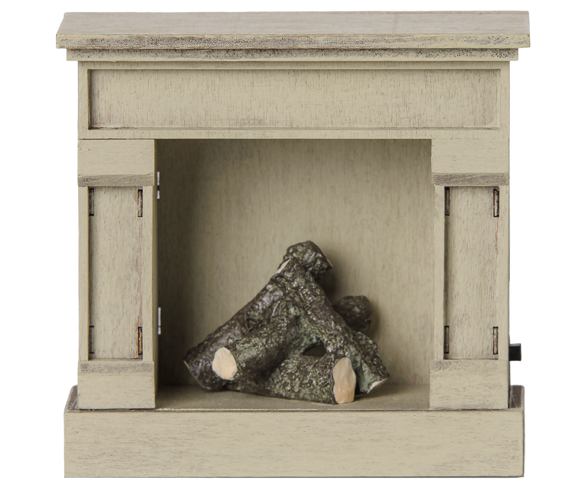 A miniature off-white vintage-style wooden toy fireplace with a rustic finish, featuring stacked realistic logs inside the hearth against a transparent background.