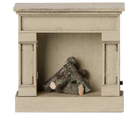 A miniature off-white vintage-style wooden toy fireplace with a rustic finish, featuring stacked realistic logs inside the hearth against a transparent background.