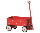 A red metal toy wagon with white polka dots, a red handle, and four wheels with cream-colored rims and black centers, shown on a black background.