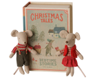 A children's book titled 'Christmas Tales: Bedtime Stories' displayed upright with two small plush mouse toys in front on a plain white background.