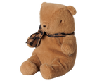 A small brown plush teddy bear by Maileg sitting upright against a transparent background, wearing a brown and black plaid bow around its neck.