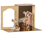 A miniature ballet scene display featuring three small plush mouse ballerina figures in pink tutus around a wooden bar, set inside a decorative patterned cardboard stage with mirrored floor panels.
