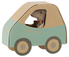 A small plush toy mouse driving a cardboard car. The car is made of light brown cardboard with a mint green lower section and has the words 'mouse mini' printed on the side.