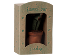 A miniature Maileg potted plant in decorative packaging designed to look like a tiny storefront or greenhouse box labeled "Flower pot" and "maileg."