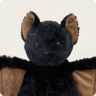 Black plush toy with brown accents on a white background