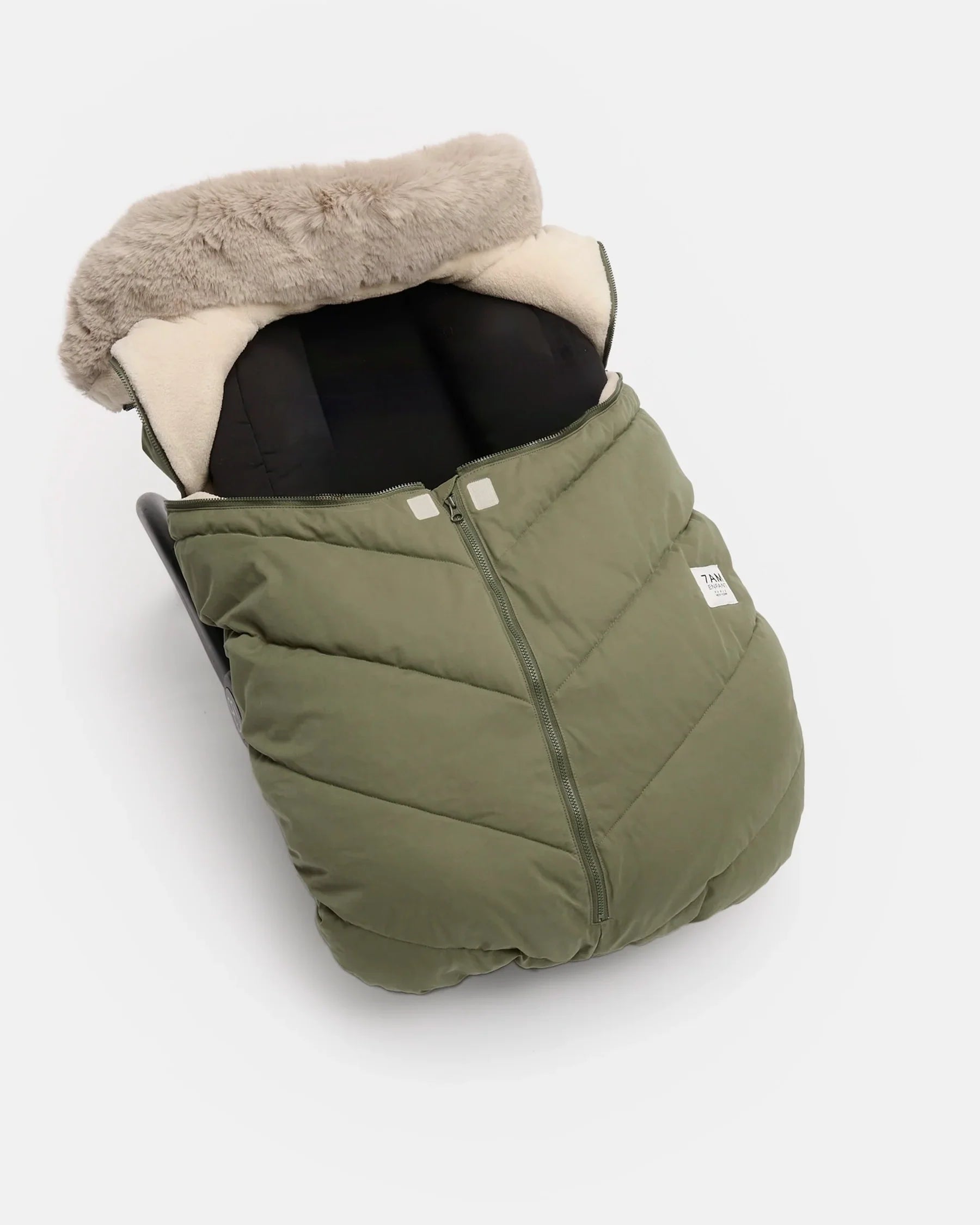 An olive green puffer baby footmuff with a beige faux-fur trim and cream interior lining, shown on a light gray background.