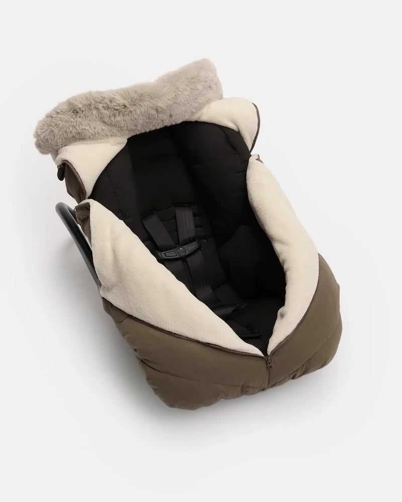 Moss brown Helsinki Car Seat Cocoon by 7AM Enfant shown installed on an infant car seat, featuring a plush faux-fur collar and harness compatibility.