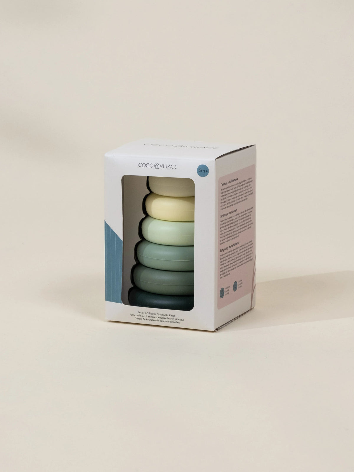 Packaging of colorful baby toys with a visible brand logo on a beige background
