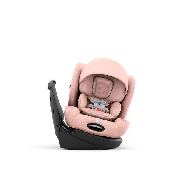 A light pink infant car seat with a black base, shown from a three-quarter angle on a solid white background.