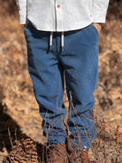 A pair of blue corduroy joggers with an elastic drawstring waist.