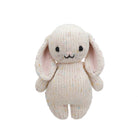Knitted bunny toy with pink ears on a white background