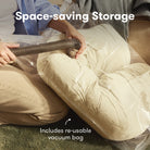 Person using a vacuum to compress a beige cushion into a clear vacuum bag with text 'Space-saving Storage' and 'Includes re-usable vacuum bag'.