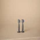 Two gray spatulas on a beige background