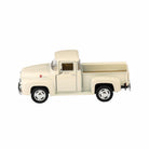 Model of a vintage cream-colored pickup truck on a white background