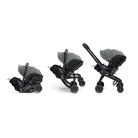 Three views of a baby stroller and car seat travel system in dark gray and black, shown on a plain white background.