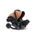 Brown and black baby car seat with canopy on a white background