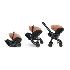 Three views of a baby stroller system with an infant car seat attachment, shown on a clean white background. The stroller and seat are black with a warm tan/beige canopy and small blue accents.