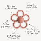 Flower-shaped teething toy with text highlighting its features on a white background