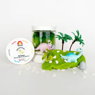 Dinosaur play kit with figures, palm trees, and a container on a white background