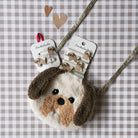 Dog-shaped hair clip and hair ties on a checkered background