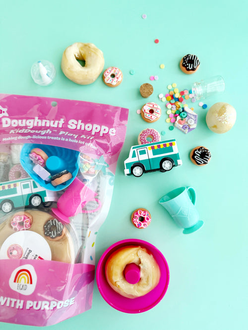 Doughnut-themed play set with toys and donut-shaped items on a light blue background