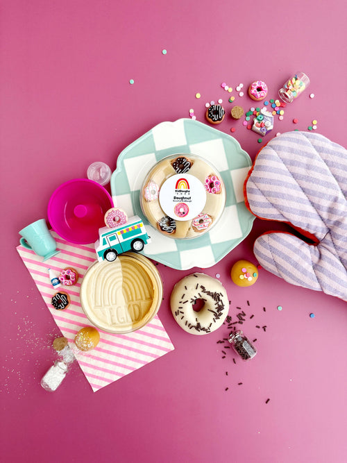 Decorative plates with donut designs on a pink background