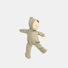 Toy doll in a green onesie on a white background