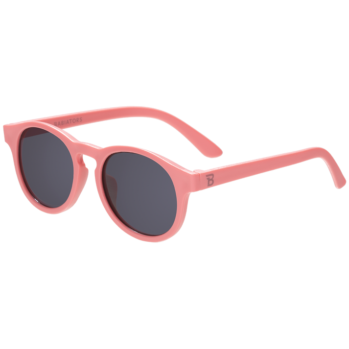 Pink sunglasses with dark lenses on a white background