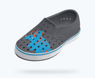 Gray clog shoe with blue dinosaur design on a white background