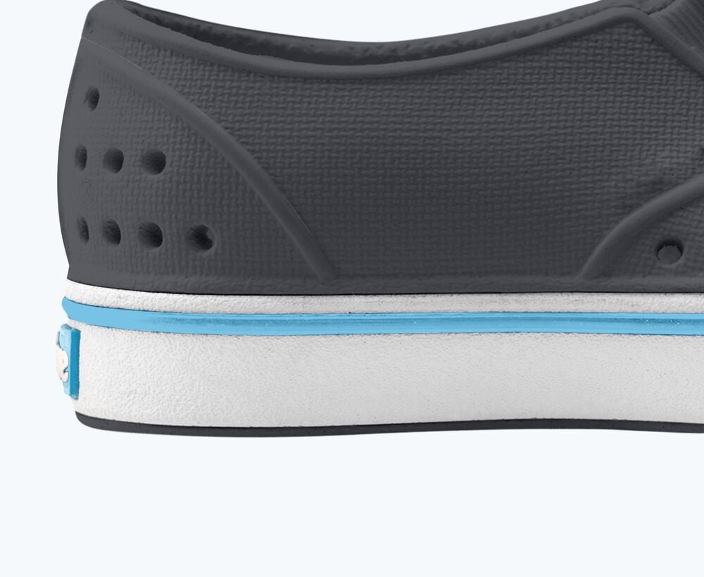 Close-up of a shoe sole with gray, white, and blue color scheme on a white background