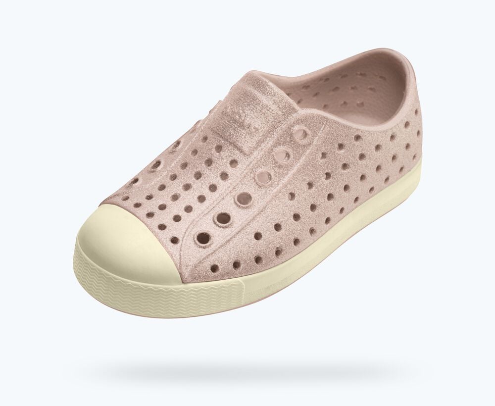 Pink slip-on shoe with white sole on a light gray background