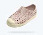 Pink slip-on shoe with white sole on a light gray background