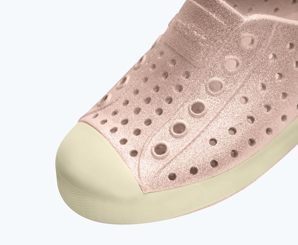 Close-up of a pink slip-on shoe with a white background