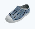 Blue slip-on shoe with white sole on a white background