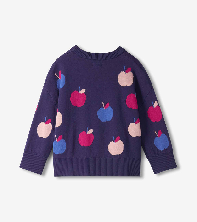 A dark purple knit sweater with an all-over pattern of stylized apples in pink, blue, and red, shown against a light gray background.