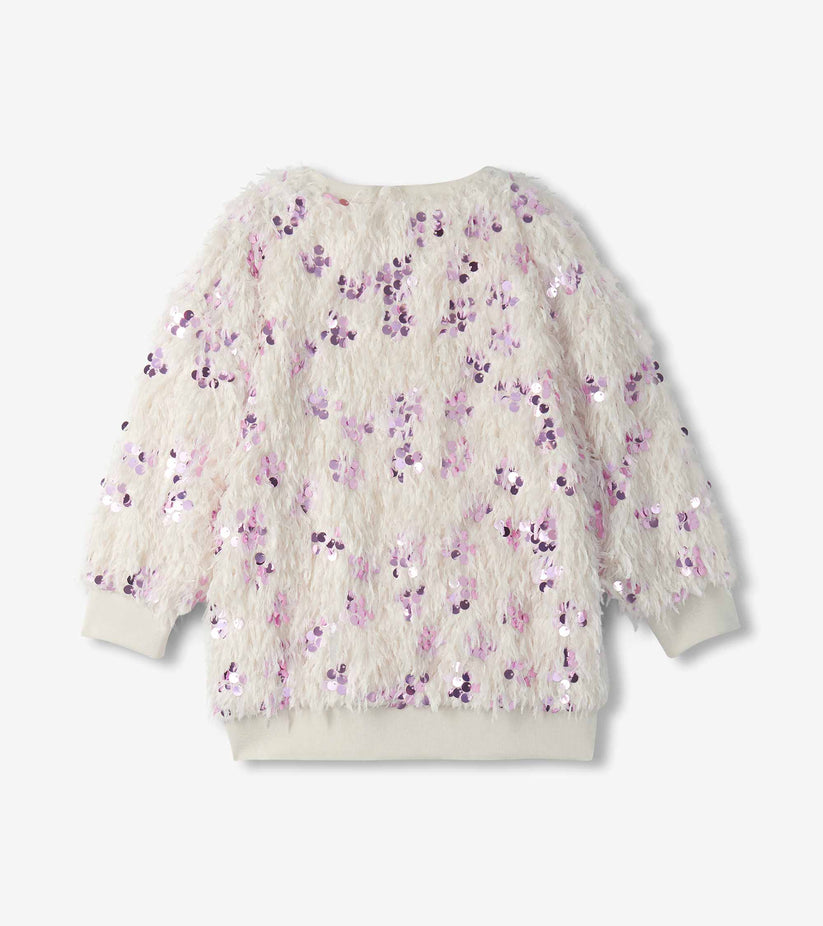 A long-sleeve fuzzy knit sweater in cream with an all-over sequined floral pattern in shades of purple and pink, displayed flat against a light gray background.