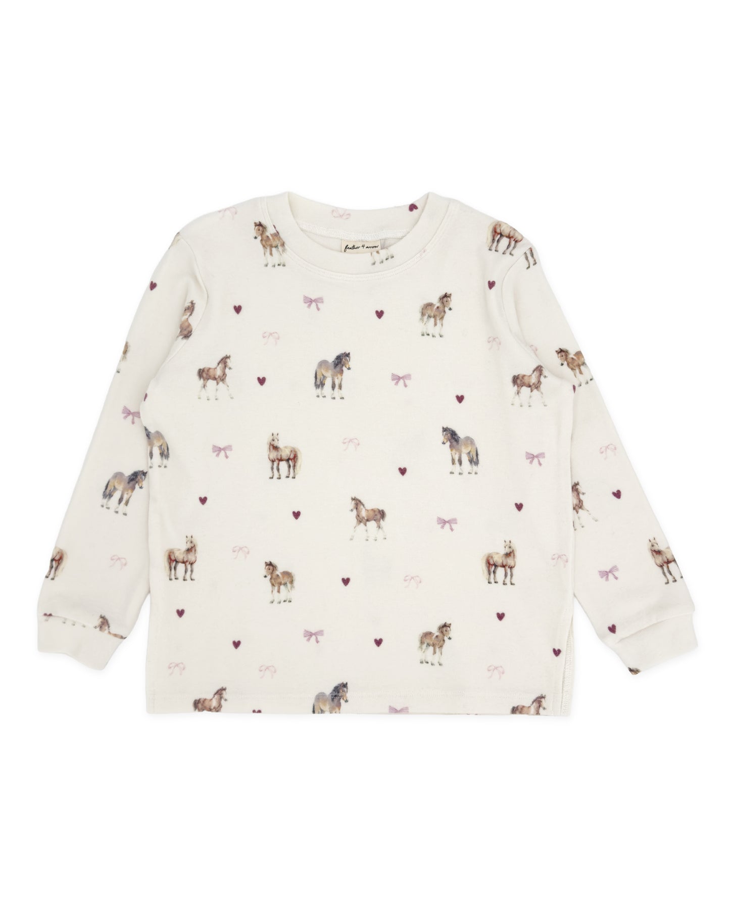 An off-white long-sleeve children's top with an all-over print of horses, ponies, and small pink hearts, shown flat against a white background.