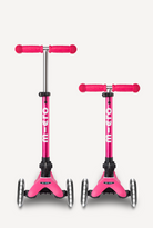 Two pink Micro scooters on a white background