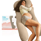 Pregnant woman using a full-body support pregnancy pillow with 'frida' branding.