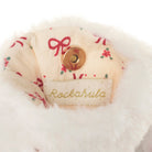 Close-up of a plush white faux-fur trim with a cream fabric lining printed with red bows and small red floral motifs, featuring a gold snap button and a visible Rockahula brand label.