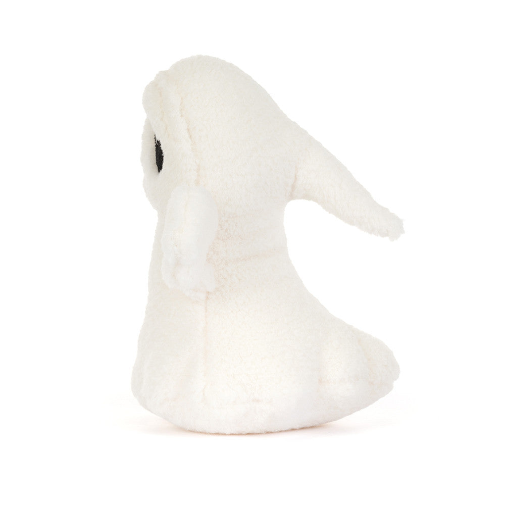 A small white plush bunny toy with a single black eye, photographed against a seamless white background.